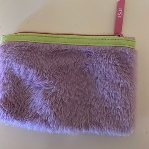 A small cosmetic bag.  purple and green and cute. Reminds me of scoobydoo/AKA